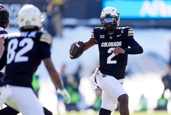 Colorado quarterback Shedeur Sanders looks to pass the ball to wide receiver Terrell Timmons Jr. in the first half of an NCAA college football game against Oklahoma State Friday, Nov. 29, 2024, in Boulder, Colo. (AP Photo/David Zalubowski)