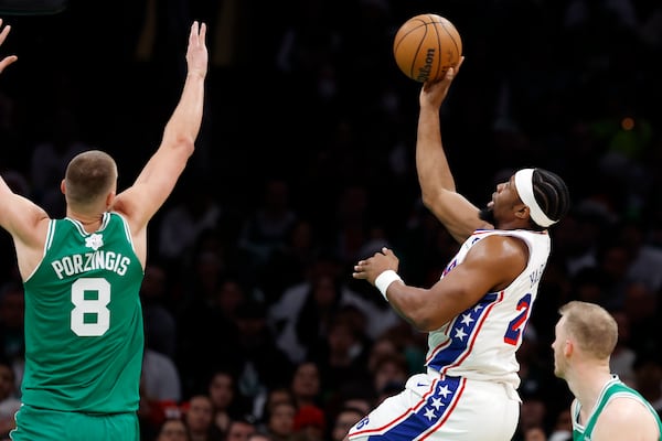 Philadelphia 76ers' Guerschon Yabusele scores against Boston Celtics' Kristaps Porzingis (8) during the first half of an NBA basketball game, Wednesday, Dec. 25, 2024, in Boston (AP Photo/Michael Dwyer)