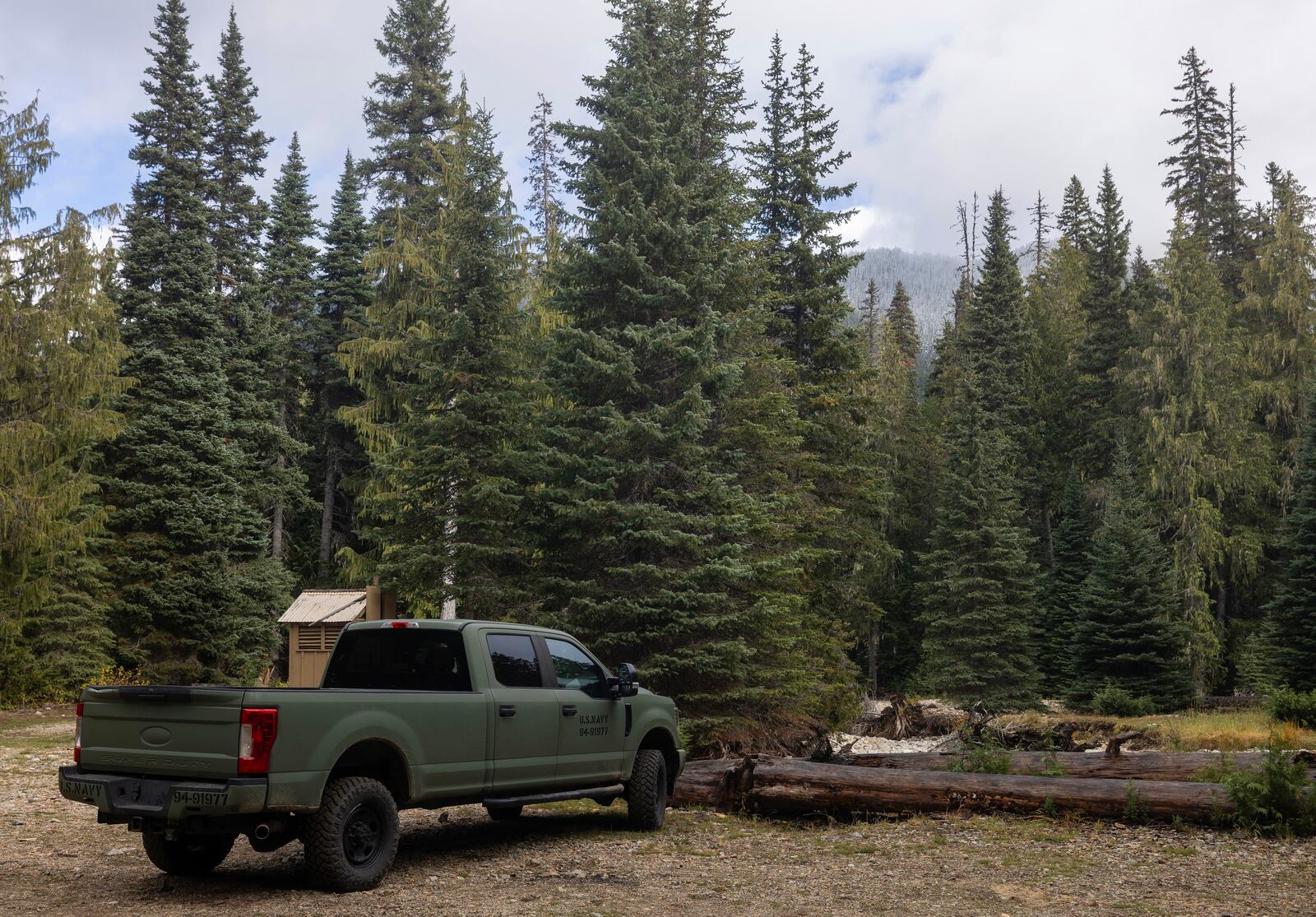 A U.S. Navy pickup truck is seen in a parking lot near Pear Butte, Yakima County, on Thursday, Oct. 17, 2024, as the search continues for two fighter pilots whose EA-18G Growler jet crashed east of Mount Rainier, Wash. (Nick Wagner/The Seattle Times via AP)