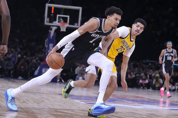 San Antonio Spurs center Victor Wembanyama (1) drives to the basket against Indiana Pacers guard Ben Sheppard (26) during the second half of a Paris Games 2025 NBA basketball game in Paris, Thursday, Jan. 23, 2025. (AP Photo/Thibault Camus)