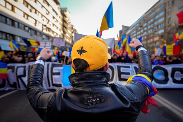 A protester shouts slogans and gestures during a rally organized by the right wing Alliance for the Unity of Romanians (AUR), calling for free elections after Romania' s Constitutional Court annulled the first round of presidential elections last December, in Bucharest, Romania, Sunday, Jan. 12, 2025.(AP Photo/Vadim Ghirda)