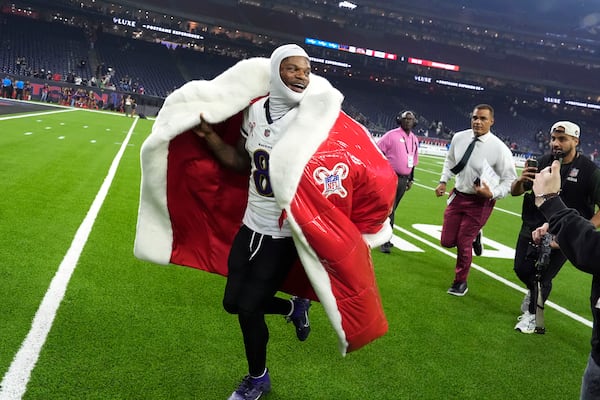 Baltimore Ravens quarterback Lamar Jackson (8) runs off the field after an NFL football game against the Houston Texans, Wednesday, Dec. 25, 2024, in Houston. (AP Photo/David J. Phillip)