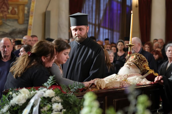 A girl pays his respects to the late Archbishop Anastasios of Tirana, Durres and All Albania during his funeral, inside the Cathedral of the Resurrection of Christ, in Tirana, Albania, Thursday, Jan. 30, 2025. (AP Photo/Vlasov Sulaj)