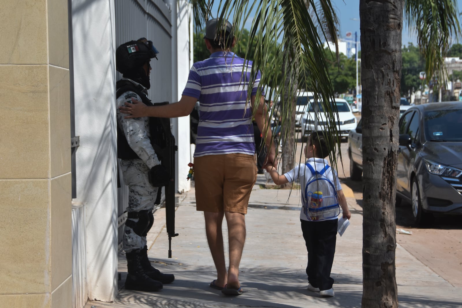 A resident pats a National Guard on the arm after picking a child up from school in Culiacan, Sinaloa state, Mexico, Monday, Oct. 14, 2024. (AP Photo)