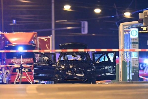 A damaged car sits with its doors open after a driver plowed into a busy Christmas market in Magdeburg, Germany, early Saturday, Dec. 21, 2024. (Hendrik Schmidt/dpa via AP)