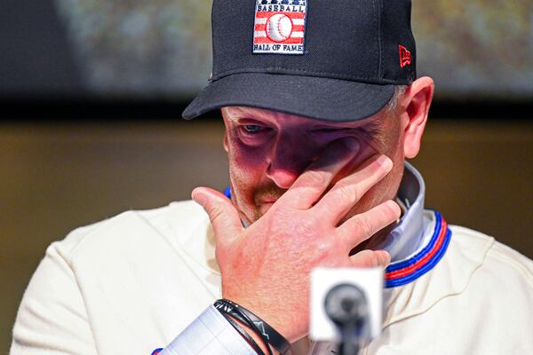 Newly-elected Baseball Hall of Fame inductee Billy Wagner wipes his eye while talking to reporters during a news conference Thursday, Jan. 23, 2025, in Cooperstown, N.Y. (AP Photo/Hans Pennink)