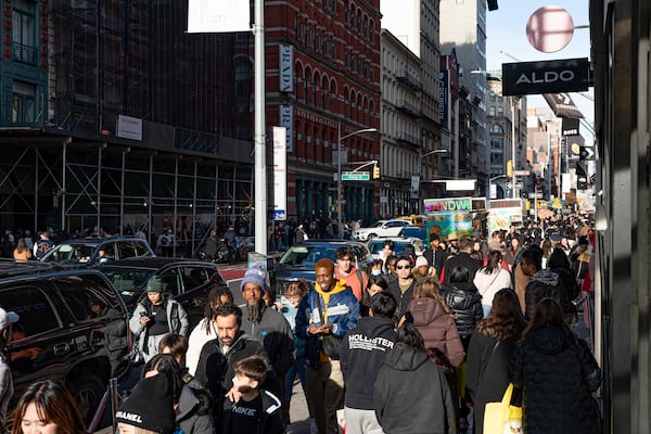 FILE - Shoppers and others walk down a crowded sidewalk on Black Friday in the Soho neighborhood of New York, Nov. 24, 2023. (AP Photo/Peter K. Afriyie, File)