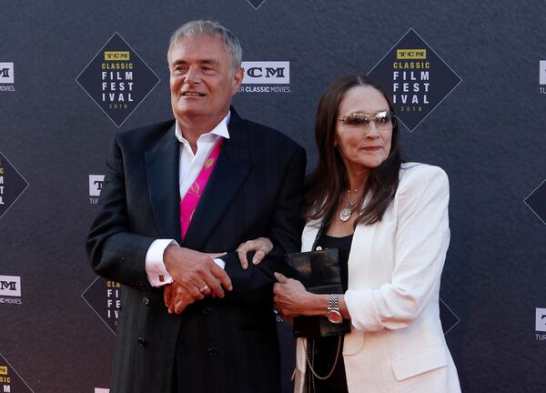 FILE - Leonard Whiting, left, and Olivia Hussey arrive at the screening of "The Producers" at the 2018 TCM Classic Film Festival Opening Night at the TCL Chinese Theatre on April 26, 2018, in Los Angeles. (Photo by Willy Sanjuan/Invision/AP, File)