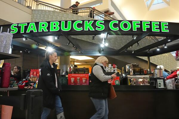 FILE - Shoppers at the Walden Galleria in Buffalo, NY, stop by the Starbucks kiosk on Nov. 30, 2024. (AP Photo/Gene J. Puskar, File)