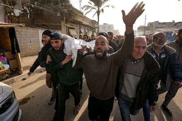 Mourners react as they carry the bodies of five Palestinian journalists who were killed by an Israeli airstrike in Gaza City at the Al-Aqsa Hospital in Deir al-Balah, Thursday, Dec. 26, 2024. (AP Photo/Abdel Kareem Hana)