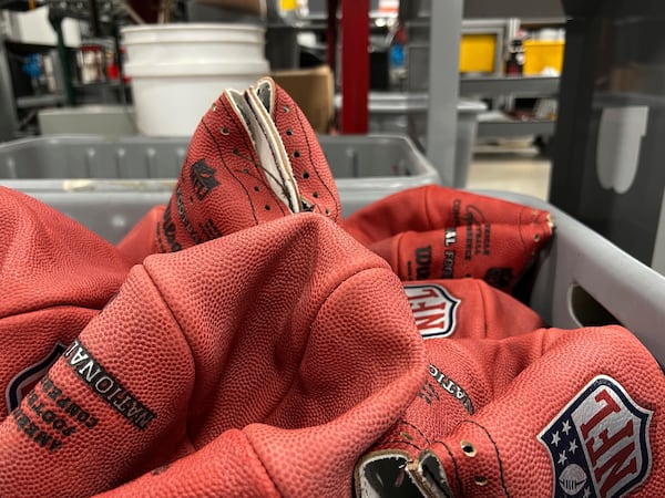 A bin of official balls for the NFL Super Bowl football game wait to be finished inside the Wilson Sporting Goods football factory, Monday, January 27, 2025, in Ada, Ohio. (AP Photo/Patrick Aftoora-Orsagos)