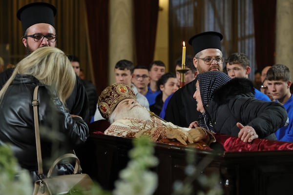 A woman pays her respects to the late Archbishop Anastasios of Tirana, Durres and All Albania during a religious ceremony, a day before his funeral, inside the Cathedral of the Resurrection of Christ, in Tirana, Albania, Wednesday, Jan. 29, 2025. (AP Photo/Vlasov Sulaj)