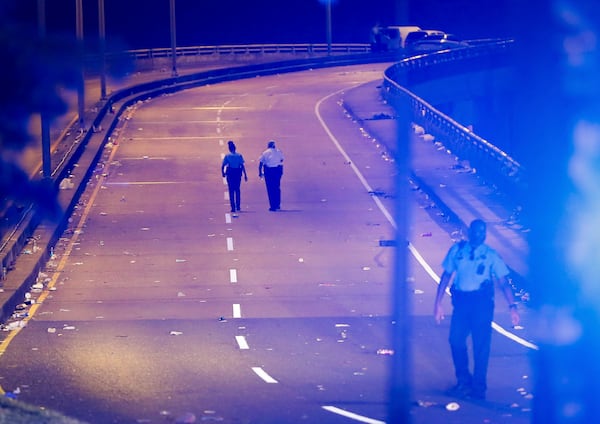 New Orleans police walk up the Almonaster Avenue bridge after a deadly shooting in New Orleans, Sunday, Nov. 17, 2024. (David Grunfeld/The Times-Picayune/The New Orleans Advocate via AP)