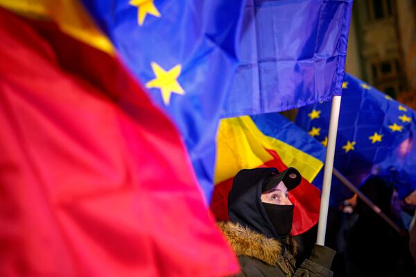 A man waving an European Union flag attends a pro-European rally ahead of the country's Dec. 8 runoff presidential elections in Bucharest, Romania, Thursday, Dec. 5, 2024. (AP Photo/Andreea Alexandru)