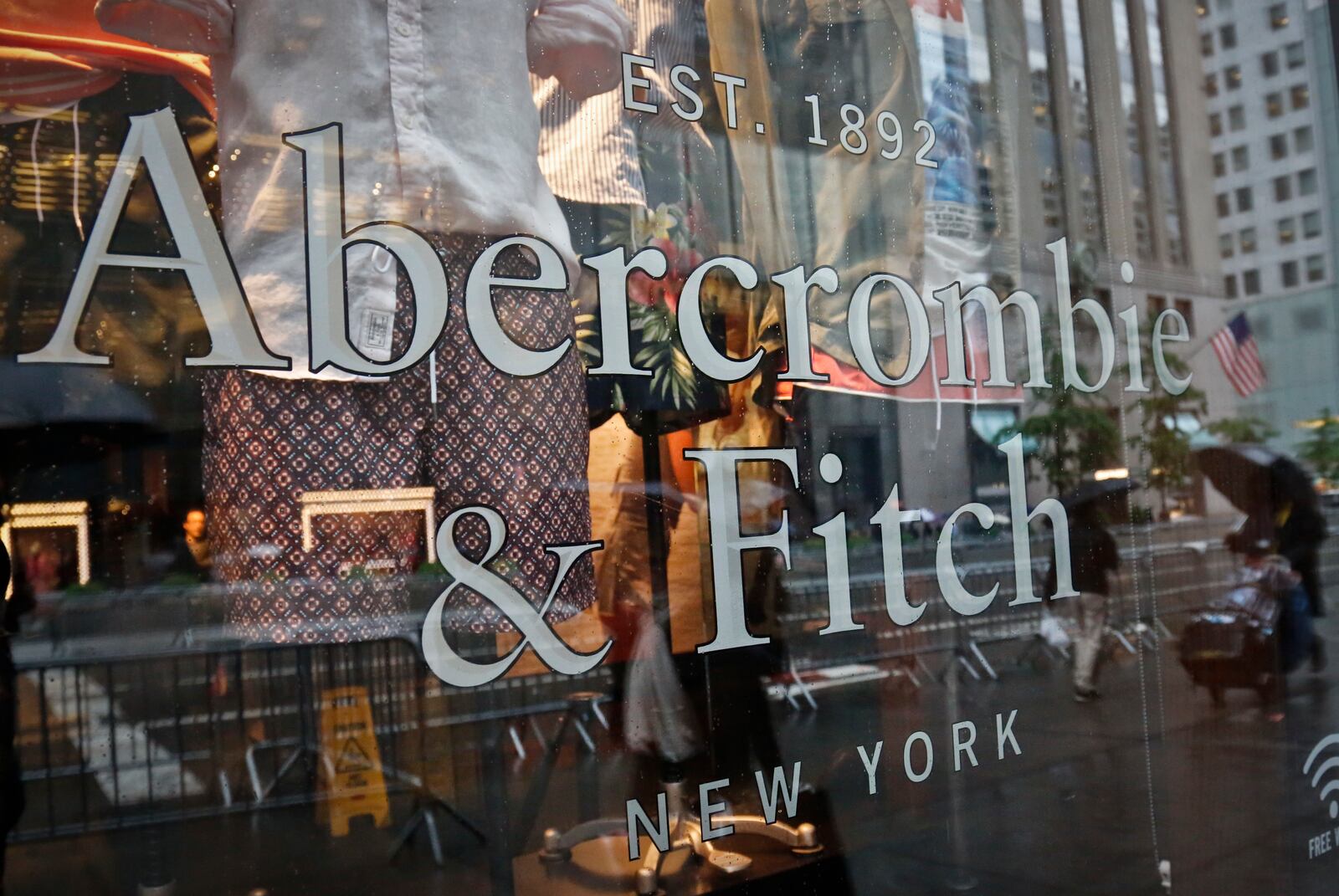 FILE - In this May 22, 2017, file photo, a store window reflects a street scene at an Abercrombie & Fitch store on New York's Fifth Avenue. (AP Photo/Bebeto Matthews, File)