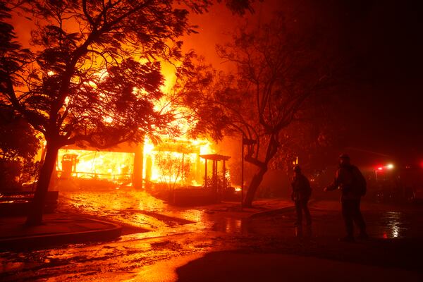 FILE - Firefighters battle the Palisades Fire in the Pacific Palisades neighborhood of Los Angeles, Tuesday, Jan. 7, 2025. (AP Photo/Etienne Laurent, File)