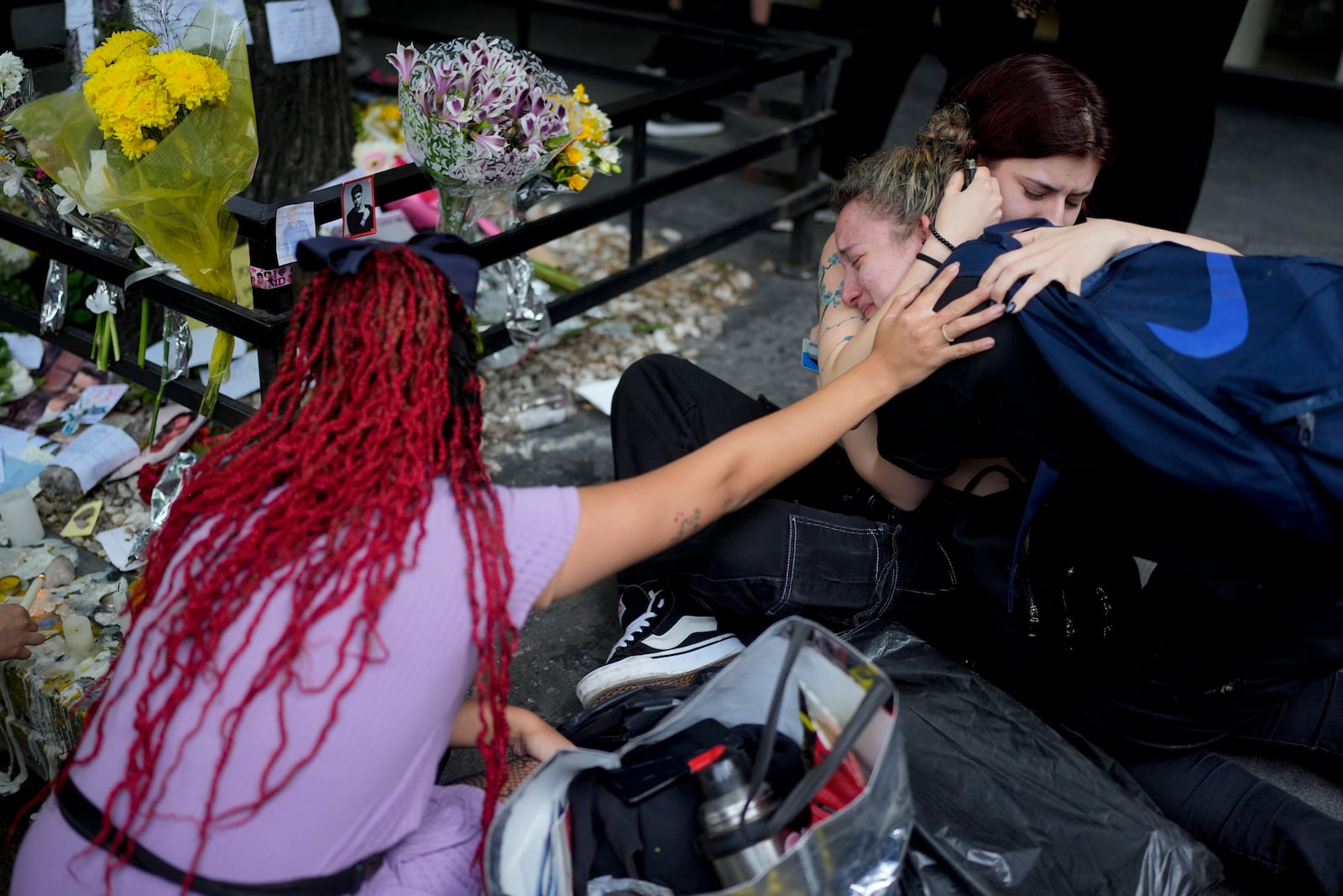 Fans of former One Direction singer Liam Payne gather outside the hotel where he was found dead after falling from a balcony in Buenos Aires, Argentina, Thursday, Oct. 17, 2024. (AP Photo/Natacha Pisarenko)