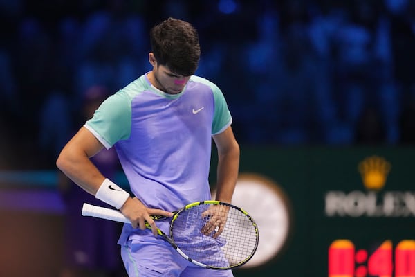 Spain's Carlos Alcaraz reacts during the singles tennis match of the ATP World Tour Finals against Germany's Alexander Zverev, at the Inalpi Arena, in Turin, Italy, Friday, Nov. 15, 2024. (AP Photo/Antonio Calanni)