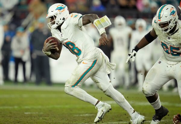 Miami Dolphins quarterback Tyler Huntley (18) runs during the second half of an NFL football game against the Cleveland Browns Sunday, Dec. 29, 2024, in Cleveland. (AP Photo/Sue Ogrocki)