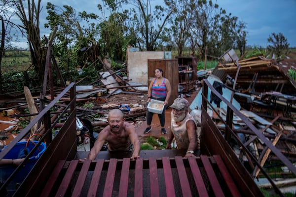 FILE - People recover belongings from their houses, which were destroyed by Hurricane Rafael, in Alquizar, Cuba, Nov. 7, 2024. (AP Photo/Ramon Espinosa, File)