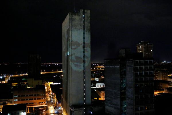 FILE - An image of communist leader Miguel Angel Soler, who disappeared in 1975 during the Stroessner dictatorship, is projected on a building in Asuncion, Paraguay, Feb. 9, 2017. (AP Photo/Jorge Saenz, File)