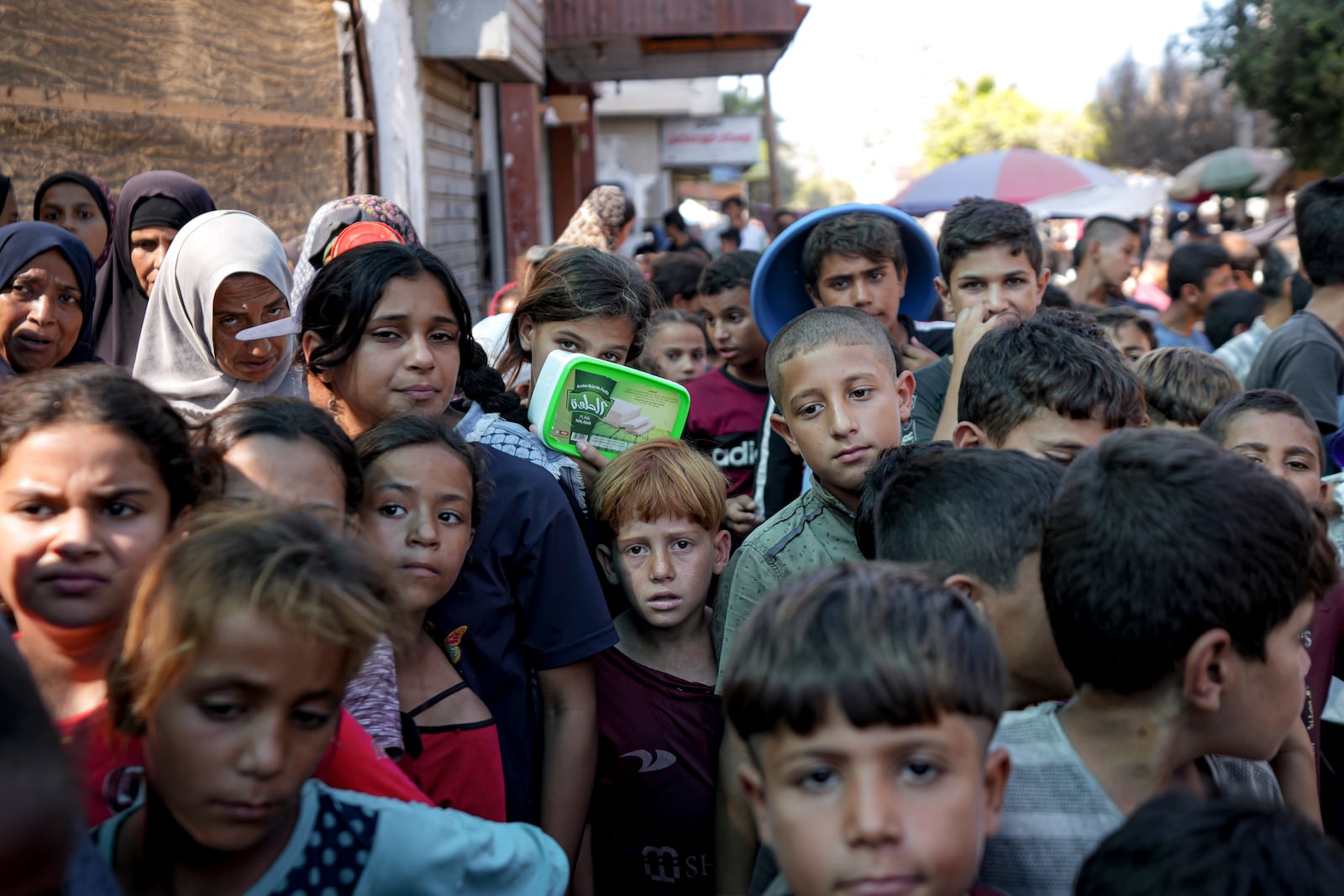 FILE - Palestinians line up for food distribution in Deir al-Balah, Gaza Strip, on Oct. 17, 2024. (AP Photo/Abdel Kareem Hana, File)