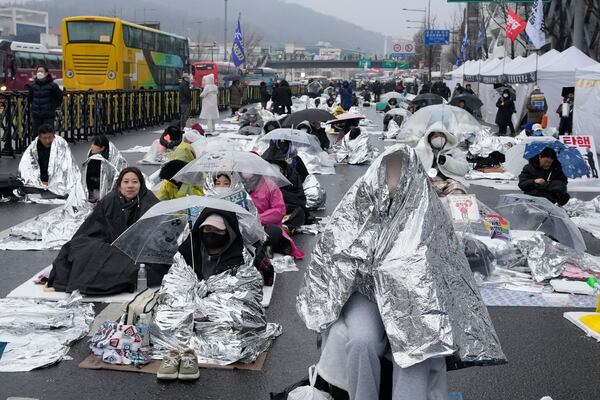 Protesters wait for a rally demanding the arrest of impeached South Korean President Yoon Suk Yeol near the presidential residence in Seoul, South Korea, Monday, Jan. 6, 2025. (AP Photo/Ahn Young-joon)