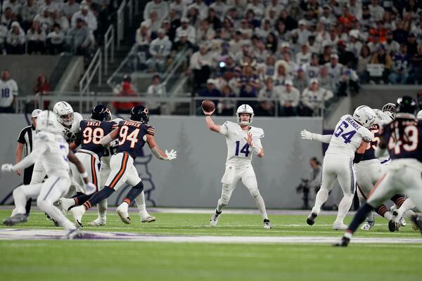 Minnesota Vikings quarterback Sam Darnold (14) throws a pass during the first half of an NFL football game against the Chicago Bears, Monday, Dec. 16, 2024, in Minneapolis. (AP Photo/Abbie Parr)