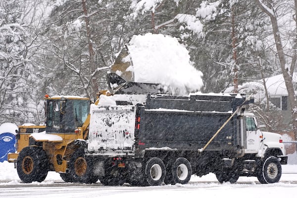 Snow is cleared from a Highmark Stadium parking lot for a Sunday Night Football game between the Buffalo Bills and the San Francisco 49ers on Sunday, Dec. 1, 2024 in Orchard Park, N.Y. (AP Photo/Gene J. Puskar)