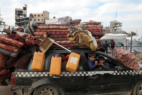 Displaced Palestinians arrive in the northern Gaza Strip, following Israel's decision to allow thousands of them to go back for the first time since the early weeks of the 15-month war with Hamas, Tuesday, Jan. 28, 2025. (AP Photo/Jehad Alshrafi)