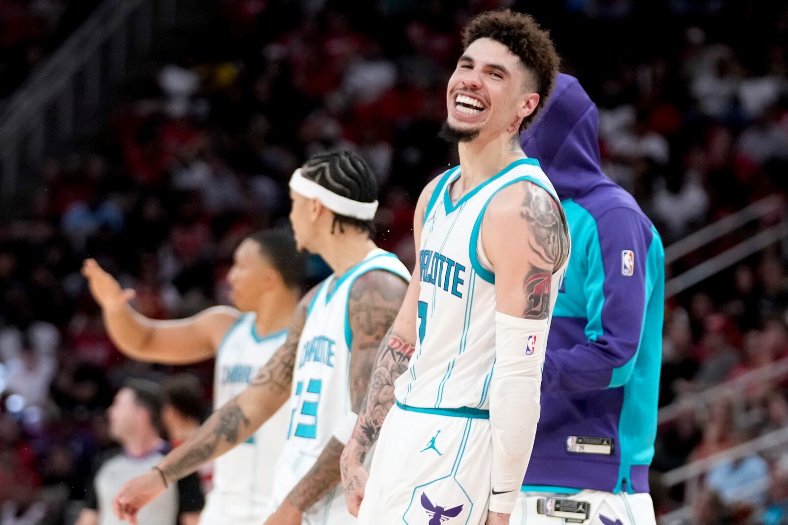 Charlotte Hornets guard LaMelo Ball, right, reacts after making a three point basket against the Houston Rockets during the second half of an NBA basketball game Wednesday, Oct. 23, 2024, in Houston. (AP Photo/Eric Christian Smith)