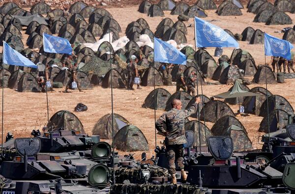 FILE - A Spanish U.N. peacekeeper stands atop an armored personnel carrier as U.N. flags are seen in the Spanish troops' new base in the southern village of Taibeh, Lebanon, Sunday, Sept. 17, 2006, as they joined the expansion of the UNIFIL peacekeeping force in Lebanon under a new Security Council resolution. (AP Photo/Alvaro Barrientos, File)