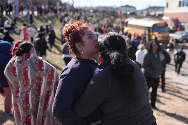 Families wait a school buses arrive at a unification site following a shooting at the Antioch High School in Nashville, Tenn., Wednesday, Jan. 22, 2025. (AP Photo/George Walker IV)