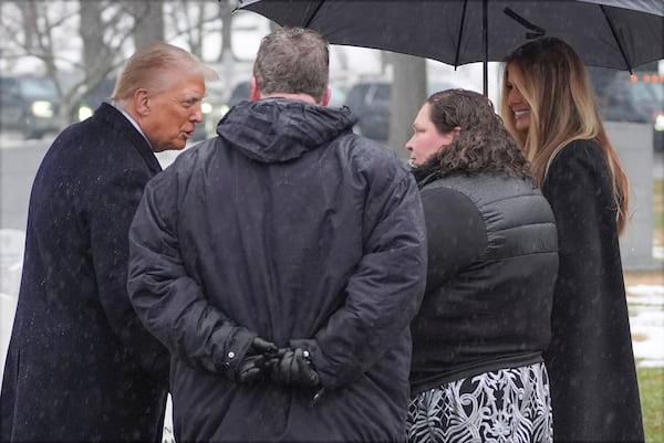 President-elect Donald Trump and Melina Trump talks with family members in Section 60 at Arlington National Cemetery, Sunday, Jan. 19, 2025, in Arlington, Va. (AP Photo/Evan Vucci)