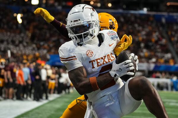 Texas wide receiver Matthew Golden (2) makes the catch for a two-point conversion against against Arizona State during overtime in the quarterfinals of a College Football Playoff game, Wednesday, Jan. 1, 2025, in Atlanta. Texas won 39-31 in two overtime periods. (AP Photo/Brynn Anderson)