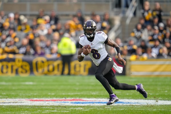 Baltimore Ravens quarterback Lamar Jackson scrambles against the Pittsburgh Steelers during the first half of an NFL football game, Sunday, Nov. 17, 2024, in Pittsburgh. (AP Photo/Gene J. Puskar)