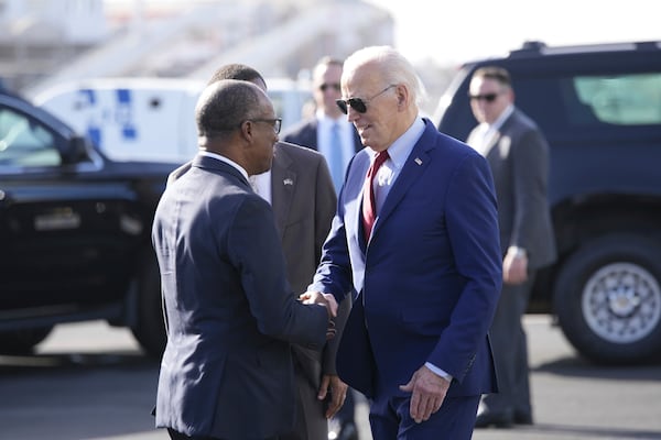 President Joe Biden is greeted by Cape Verde's Prime Minister Ulisses Correia e Silva at Amilcar Cabral international airport on Sal island, Cape Verde Monday, Dec. 2, 2024, en route to Angola as he makes his long-promised visit to Africa. (AP Photo/Ben Curtis)