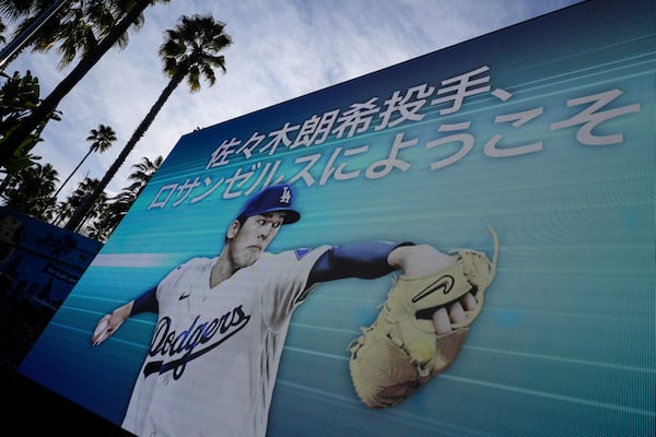 Digital display of Japanese right-hander pitcher Roki Sasaki, 23, appears at Dodger Stadium before he is introduced by the Los Angeles Dodgers at a news conference Wednesday, Jan. 22, 2025 in Los Angeles. (AP Photo/Damian Dovarganes)