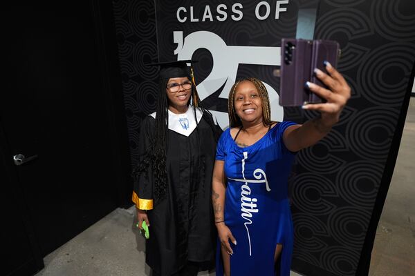 TiAnna Yeldell, right, poses with her daughter Neveh, 18, for a selfie as during senior picture day, Friday, Nov. 15, 2024, in Missouri City, Texas. (AP Photo/Eric Gay)