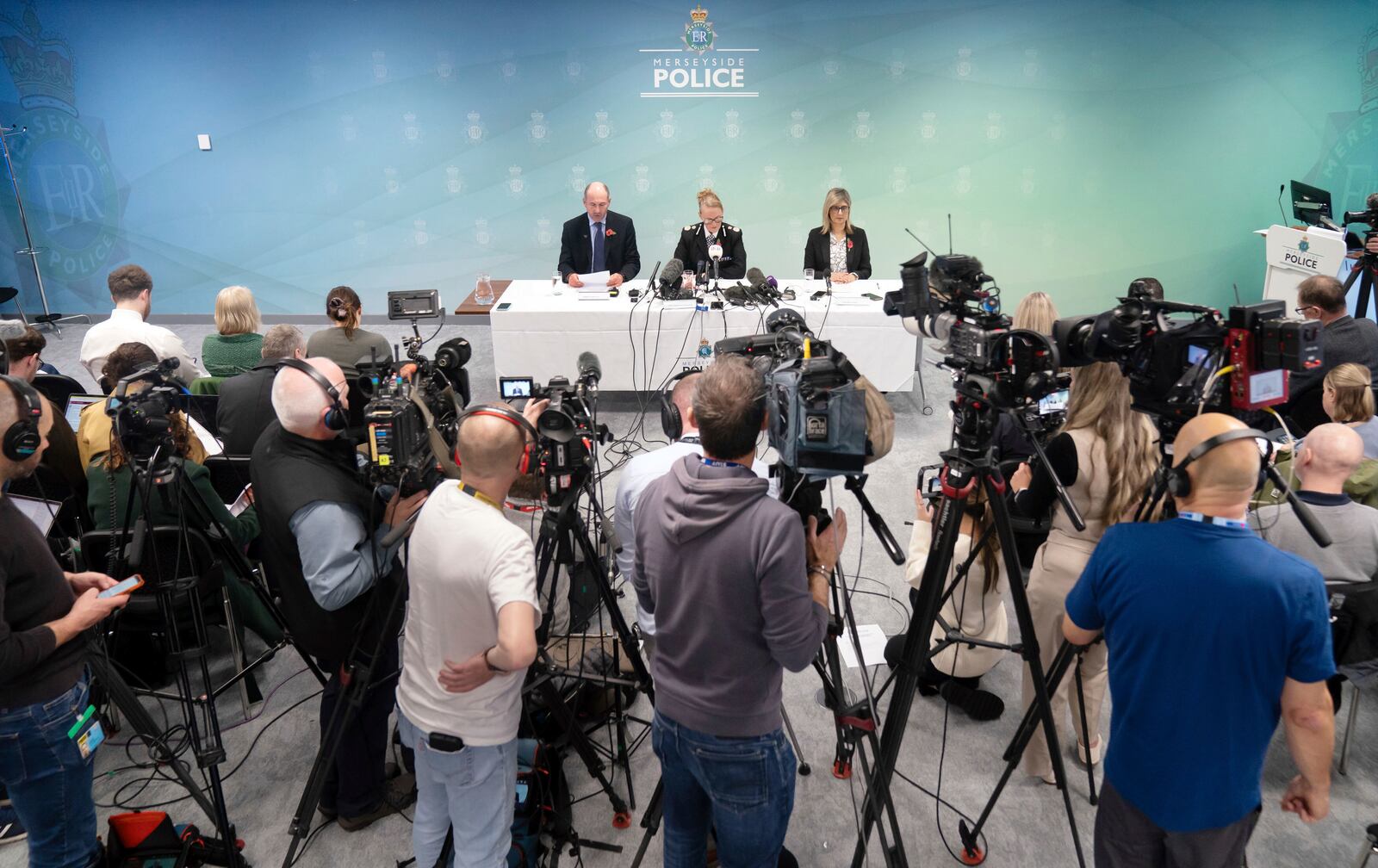 Professor Tim Atkins, Merseyside Police Chief Constable Serena Kennedy, and Dr Renu Bindra meet the press at Merseyside Police Headquarters, Liverpool, England, Tuesday, Oct. 29, 2024. Axel Rudakubana, 18, the teenager accused in a stabbing rampage that killed three girls at a Taylor Swift-themed dance class in England has been charged with producing the deadly poison ricin and faces a terror offense. (Danny Lawson/PA via AP)