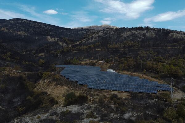 FILE - Solar panels operate near a burned forest in Acharnes suburb, on Mount Parnitha, in northwestern Athens, Greece, Aug. 27, 2023. (AP Photo/Michael Varaklas, File)