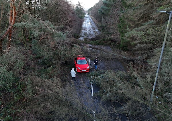 A car abandoned in Tryst Road in Larbert surrounded by fallen trees after Storm Eowyn, in Larbert, Scotland, Saturday, Jan. 25, 2025. (Andrew Milligan/PA via AP)