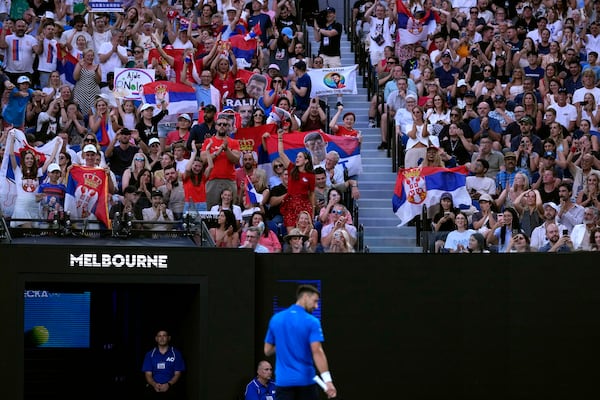 Fans of Novak Djokovic of Serbia cheer during his fourth round match against Jiri Lehecka of the Czech Republic at the Australian Open tennis championship in Melbourne, Australia, Sunday, Jan. 19, 2025. (AP Photo/Asanka Brendon Ratnayake)