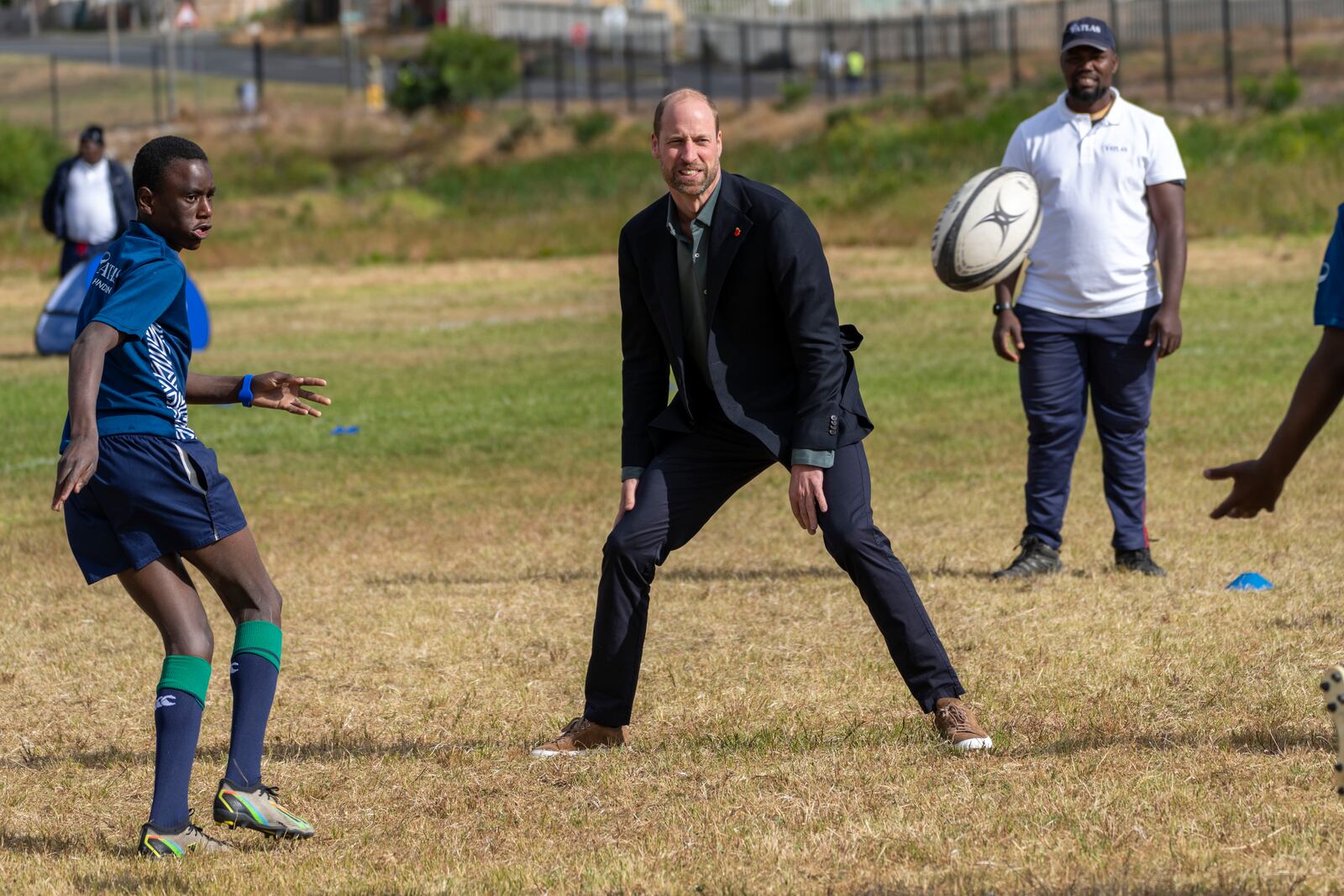 Britain's Prince William plays rugby with pupils at the Ocean View Secondary School in Cape Town, South Africa, Monday, Nov. 4, 2024. (AP Photo/Jerome Delay-pool)