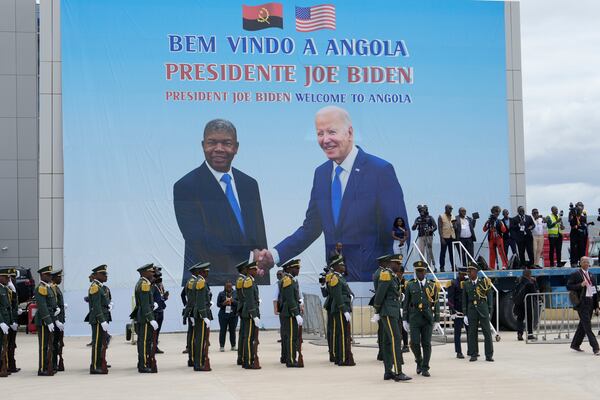 A poster showing President Joe Biden and Angola's President Joao Lourenco is seen during a welcome ceremony at Catumbela airport in Angola on Wednesday, Dec. 4, 2024. (AP Photo/Ben Curtis)