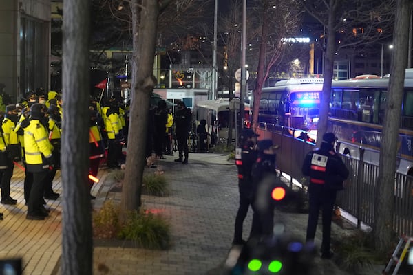 Police and barricades are placed in front of the gate of the presidential residence as supporters of impeached South Korean President Yoon Suk Yeol stage a rally to oppose a court having issued a warrant to detain Yoon, in Seoul, South Korea, Friday, Jan. 3, 2025. (AP Photo/Lee Jin-man)