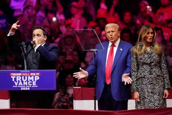 FILE - Republican presidential nominee former President Donald Trump, center, and former first lady Melania Trump, right, listen to opera singer Christopher Macchio at a campaign rally at Madison Square Garden, Oct. 27, 2024, in New York. (AP Photo/Evan Vucci, File)