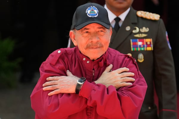 Nicaragua's President Daniel Ortega gestures to government supporters after attending the swearing-in ceremony of Venezuelan President Nicolas Maduro for a third term at the National Assembly in Caracas, Venezuela, Friday, Jan. 10, 2025. (AP Photo/Matias Delacroix)