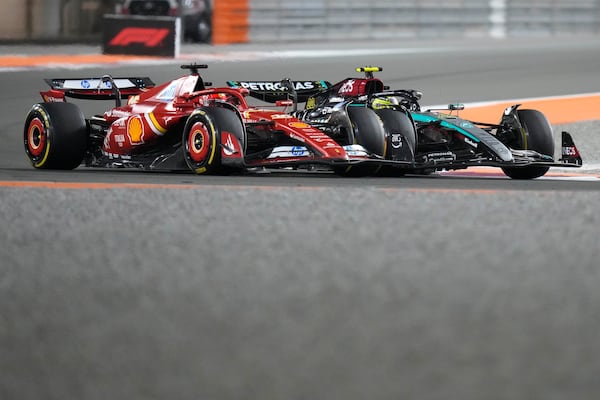 Mercedes driver Lewis Hamilton of Britain tries to overtake Ferrari driver Charles Leclerc of Monaco during sprint race at the Formula One Qatar Grand Prix, at the Lusail International Circuit in Lusail, Qatar, Saturday, Nov. 30, 2024. (AP Photo/ Darko Bandic)