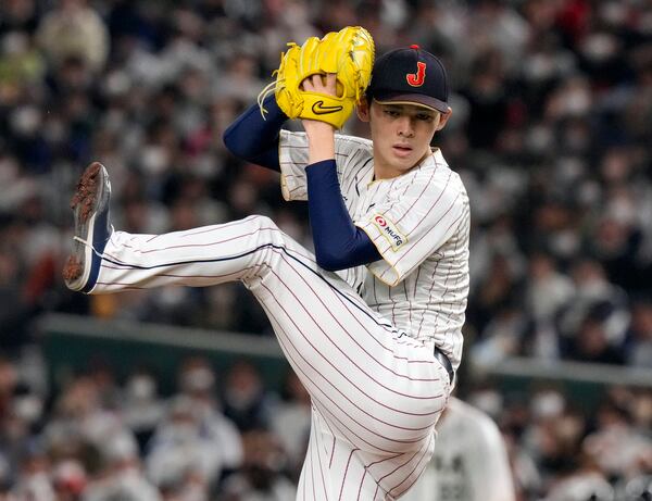 FILE - Roki Sasaki, of Japan, pitches during their Pool B game against the Czech Republic at the World Baseball Classic at the Tokyo Dome in Japan, March 11, 2023. (AP Photo/Eugene Hoshiko, File)